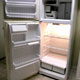 A clean refrigerator in an empty apartment
